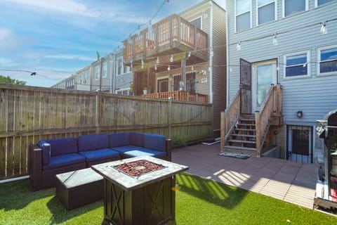 Private backyard with firepit and bistro lights