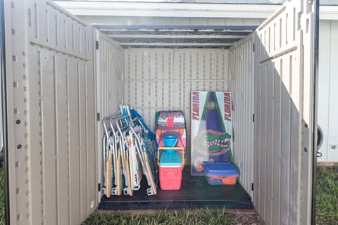 Shed with beach chairs and corn hole
