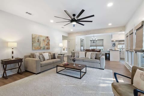 - Spacious open concept layout with plush sofas & sleek ceiling fan, perfect for movie nights & downtime - Warm wood floors & neutral tones offer a clean, calming backdrop - Natural light flows from windows to kitchen, making every corner feel bright
