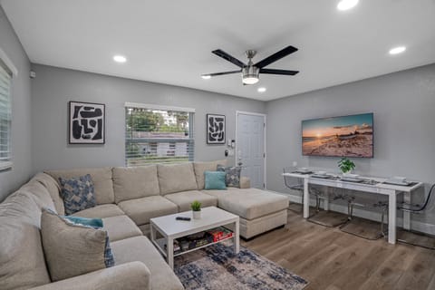 Experience modern comfort in the spacious living room, featuring a large smart flat-screen TV—perfect for streaming your favorite shows and movies.