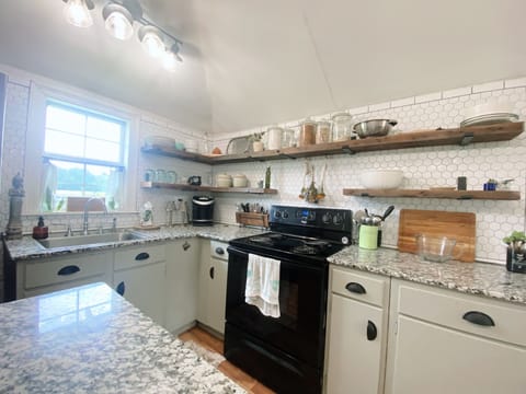 Full kitchen with island, full refrigerator, stove, oven, and microwave!