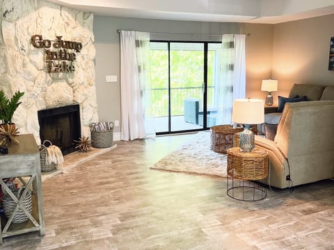 Large living room with lake views, 50" smart TV, and electric sleeper sofa.