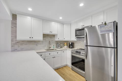 Newly remodeled with stainless steel appliances and peninsula with barstools.