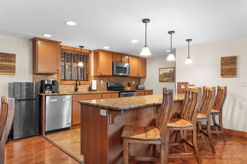 The kitchen features extra seating at the bar.