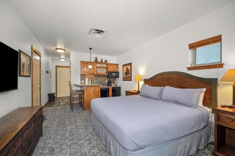 Spacious king studio with kitchenette, dining nook, and cozy lodge-style charm