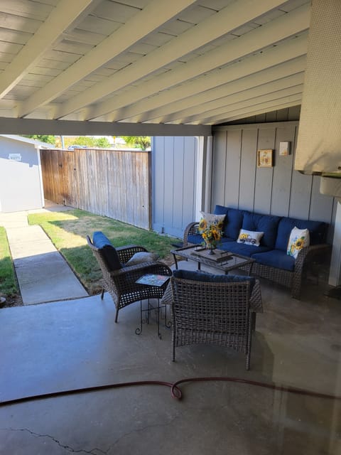 Patio seating area with barbecue cozy enough to take a nap for read a book