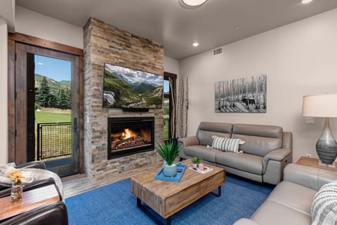 Living Room with smart TV, gas fireplace, and private deck access