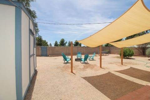 Backyard with firepit, shade sails, and seating