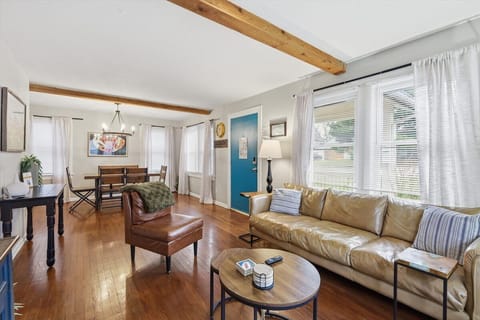 Comfortable and spacious seating area with a modern sofa, warm natural light, and charming Craftsman details—your ideal home base in Waldo KC.