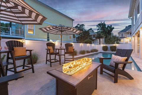 Gorgeous outdoor area with ample seating, fire pit table, pool and hot tub