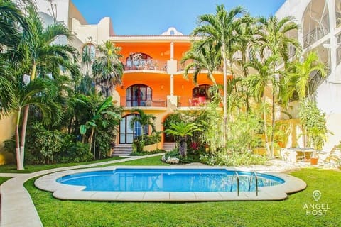 Relax by the pool surrounded by lush greenery, your perfect tropical retreat.