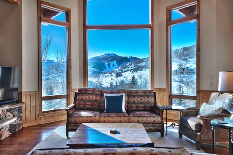 Deer Valley's Bald Mountain is framed by large picture windows in the living room and has a southwestern upholstered couch.