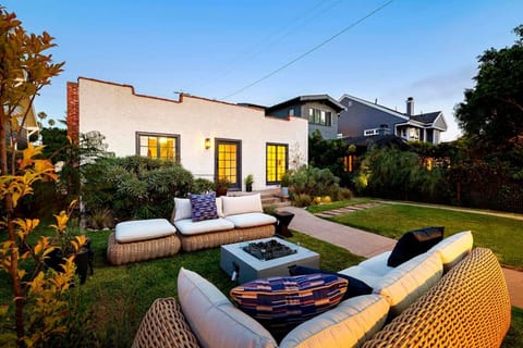 Spacious and serene—this fenced backyard with a comfy sofa is ideal for unwinding.