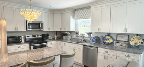 Full kitchen with range, microwave, toaster oven, dishwasher and fridge/freezer