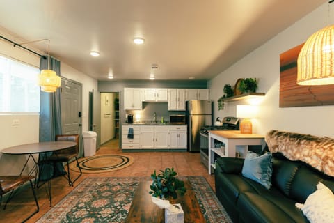 Looking from the back to the bathroom, and the generously stocked full kitchen.