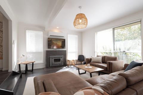 Kick back on the deep sectional by the fireplace ideal for cozy movie nights.