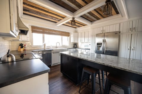 Large kitchen connecting to dining area with plenty of counter space for cooking and baking. Bar stool seating for four at the island