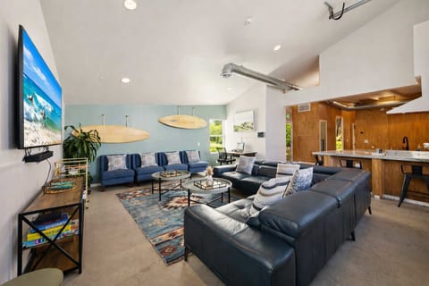 Spacious Living Room with Comfortable Seating, Large TV, and Open-Concept Design — Perfect for Relaxing and Gathering Together