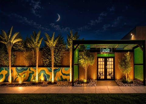 Good Life Resorts Main Entrance with Artistic Mural Wall, Palm-Lined Tropical Gateway & Warm Night Lighting — Good Life Vacation, Goodlife Events, Private Spaces, Venues for Events Beach Venues, Beach party, Party room, Holiday party, Baby shower