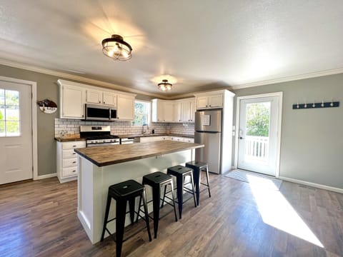 Open Floor Plan Kitchen with Bar Stool Seats and Large Island
