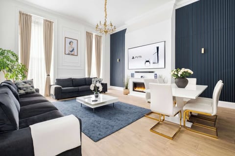 Living Room | Thoughtfully designed living room with a royal touch, the super high ceilings create an atmosphere of comfort, elegance, and distinction. Experience an impressive 90 inch TV providing a true private cinema experience.