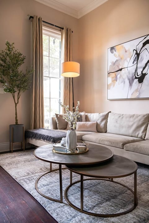 Dramatic seating area with beautiful touches, original artwork, and natural light pouring in