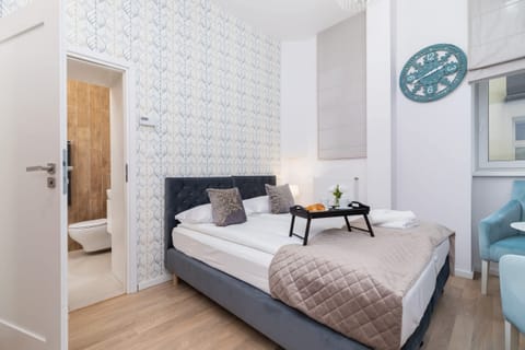 The living area features two single beds and dining area.
