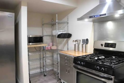 kitchen area with microwave, plates/cups/cutlery, & stove