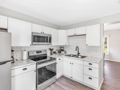 You’ll find double sinks, a refrigerator, electric oven/range, and microwave.