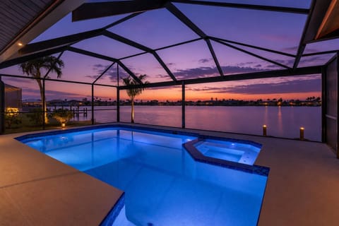 Twilight settles over this stunning lakefront retreat, creating the perfect setting for peaceful waterfront evenings in Southwest Florida.