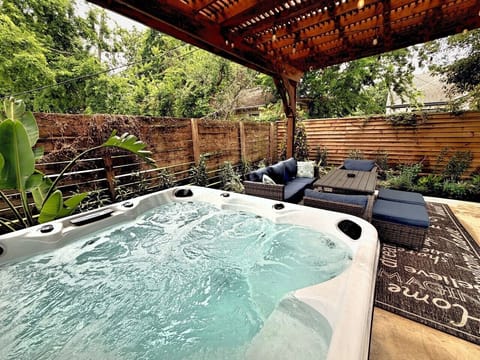 Hot tub under a covered pergola — and the whole backyard is exclusively yours.