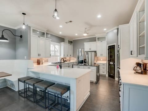 Undeniably the heart of the home with quartz countertops and stainless steel appliances, this kitchen is a dream to cook in