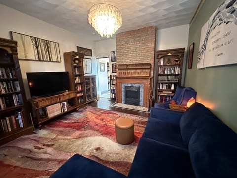 Living room. Reading material, wifi, Roku, and a comfy blue velvet seating.