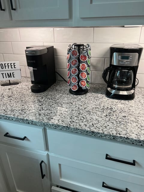 Fully stocked coffee bar with both a traditional and kuerig coffee makers.