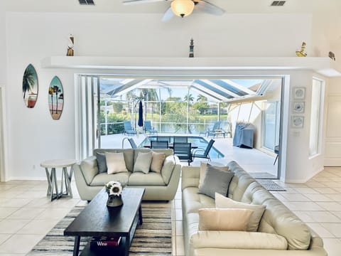 Open space living with large sliding door to pool and lake views