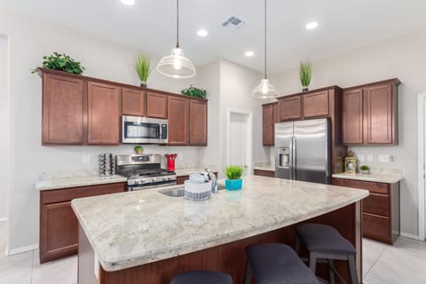 Large granite island with 3 bar stools.