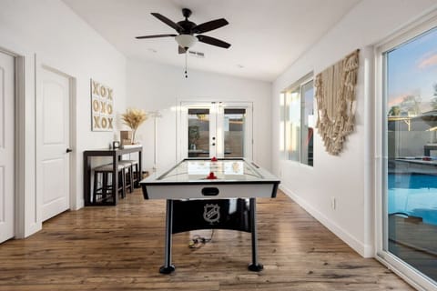 Air hockey table set up by the patio doors for easy game nights.