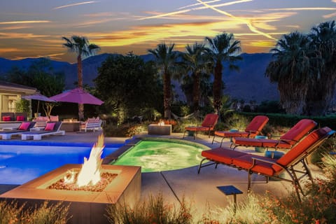 Large Spa Features Two Fire Pits and Flows Into Pool