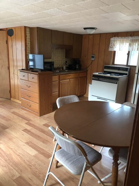 Kitchen/Dining Area features full gas range, dishes, glassware, silverware, utensils, and more