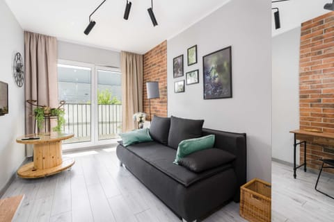 Relax in the stylish living room with a comfortable sofa and modern decor.