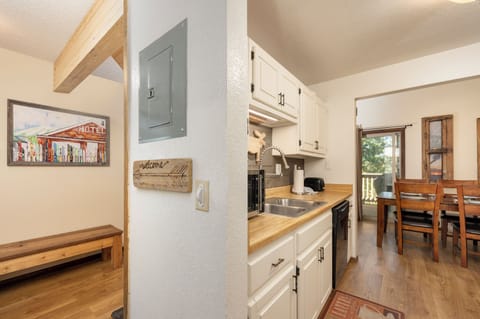 Your fully equipped galley kitchen features butcher block counters, white cabinetry, and everything you need to prepare meals during your mountain getaway.