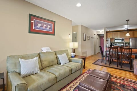 The plush couch doubles as a queen-size pull out bed while the ottomans make it easy to kick back and unwind. The living area is also open to the dining area and kitchen by way of a convenient pass-through.