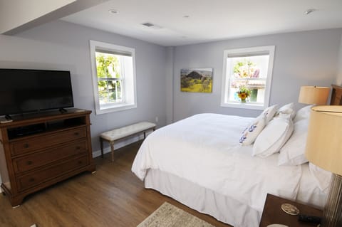 View from queen size bed of the king size bed and windows that face the plaza.