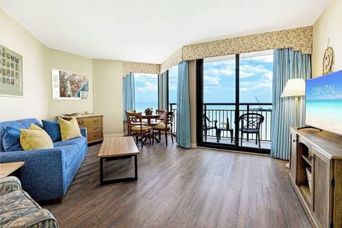 Find serenity in the living area of our oceanfront suite, where thoughtfully arranged furnishings create a tranquil space to relax by the sea.