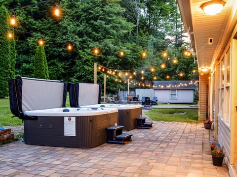 Soak in one of two brand-new hot tubs while the rest of the group claims the second — 14 seats total, no waiting your turn for the jets.