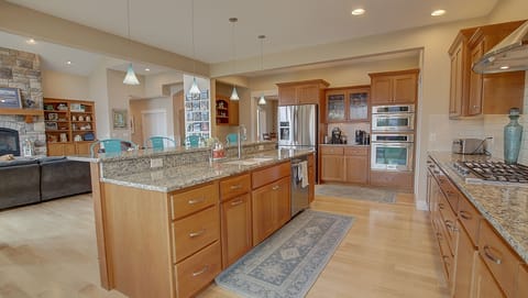 Granite counter top, custom lighting, double oven, built in desk area
