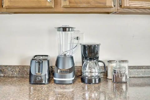 Fully equipped kitchen with fridge, oven, blender, microwave, and more.