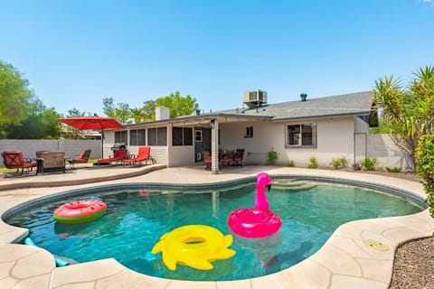 Private backyard with large 9 ft diving pool, lots of seating, and fire pit 