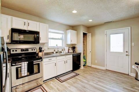 Full kitchen with exit to the back yard. 