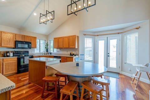 Seating for children and adults around the island. A high chair for a little one as well in this fully stocked, well equipped kitchen.